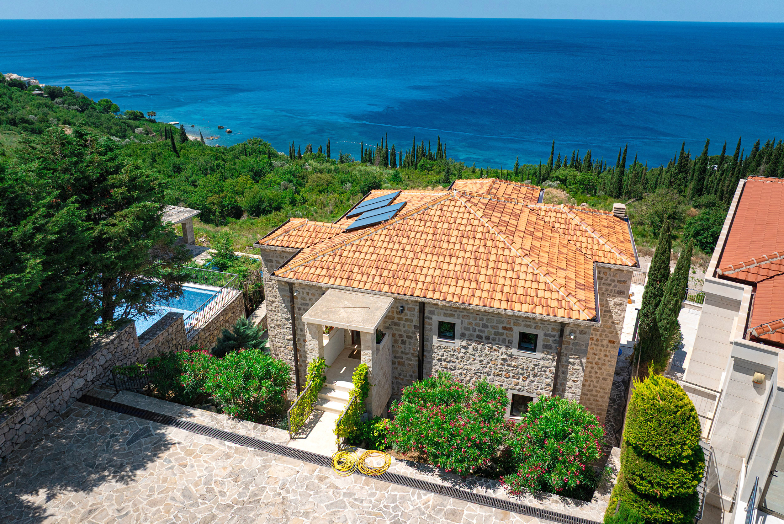 Located in Drobni Pijesak, Budva, this five-bedroom stone villa has been carefully renovated in an authentic Mediterranean style. Positioned to capture open sea views, it features a private pool and high-end interior finishes.