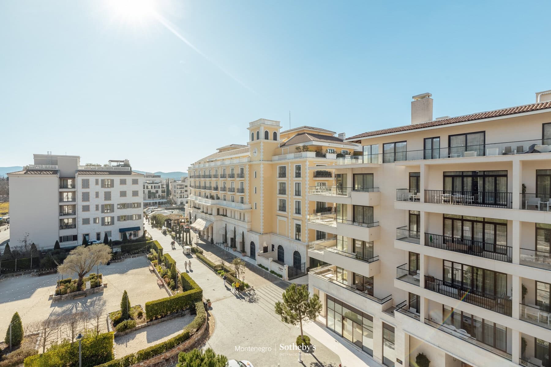 Luxury real estate Montenegro: modern apartment building with balconies and scenic views.